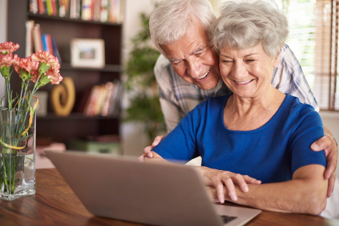 Couple Smiling at Computer