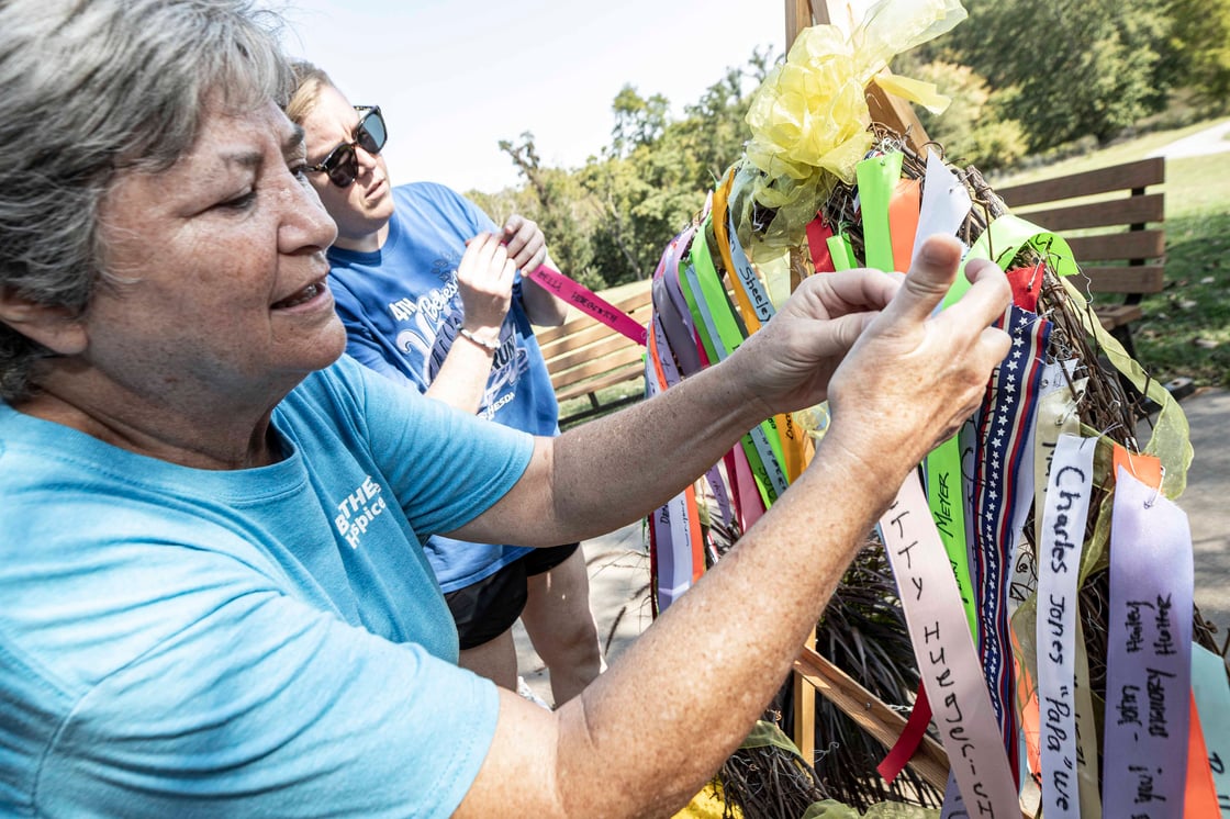 Honoring loved ones by hanging ribbons on wreath at Kayman 5K