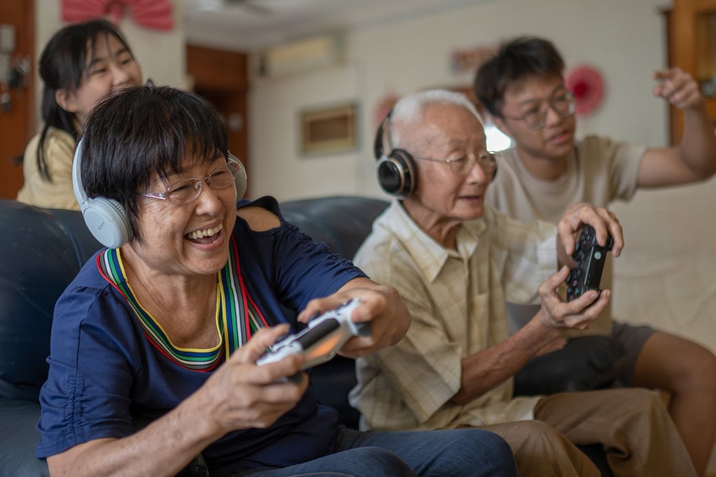 Seniors playing video games with grandchildren