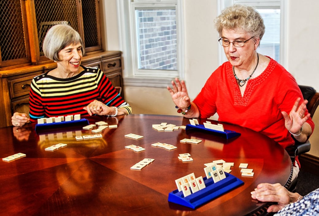Group of senior women playing table game