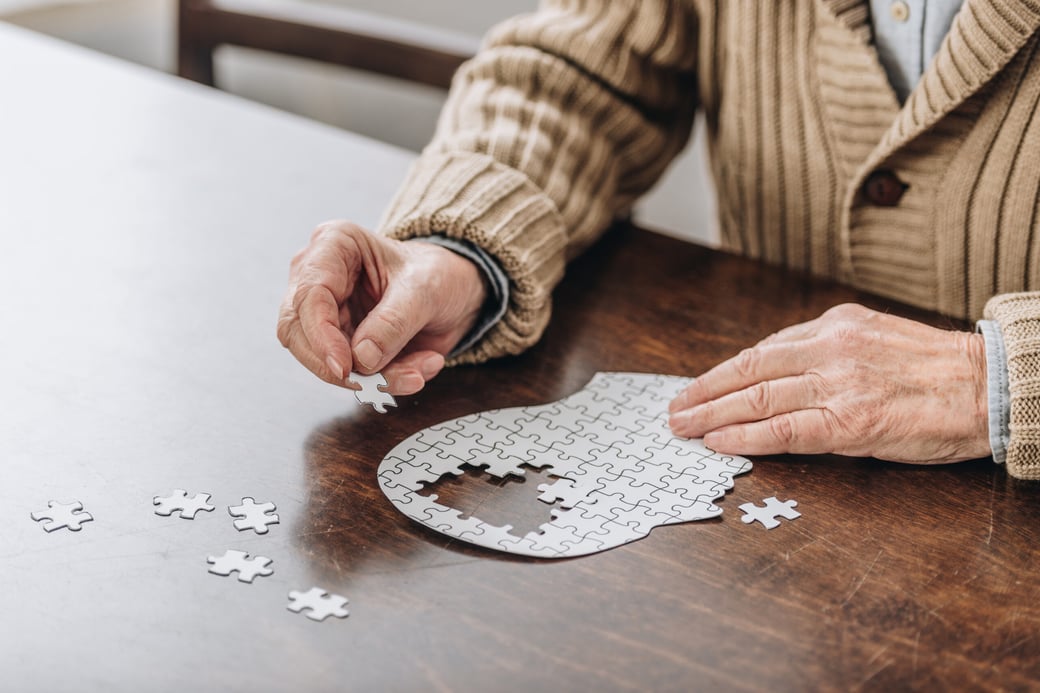 Senior putting together brain puzzle
