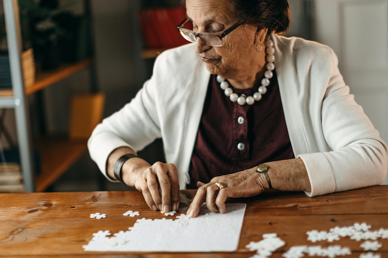 Senior woman putting a puzzle together