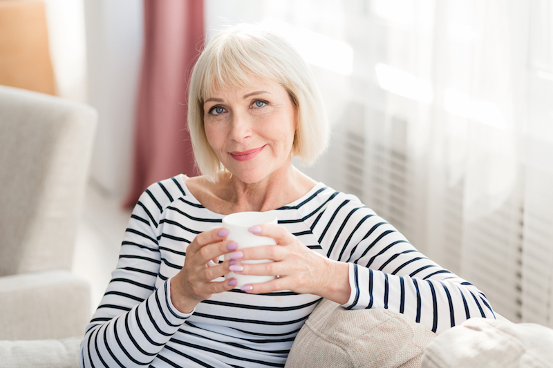 Senior woman enjoying warm beverage