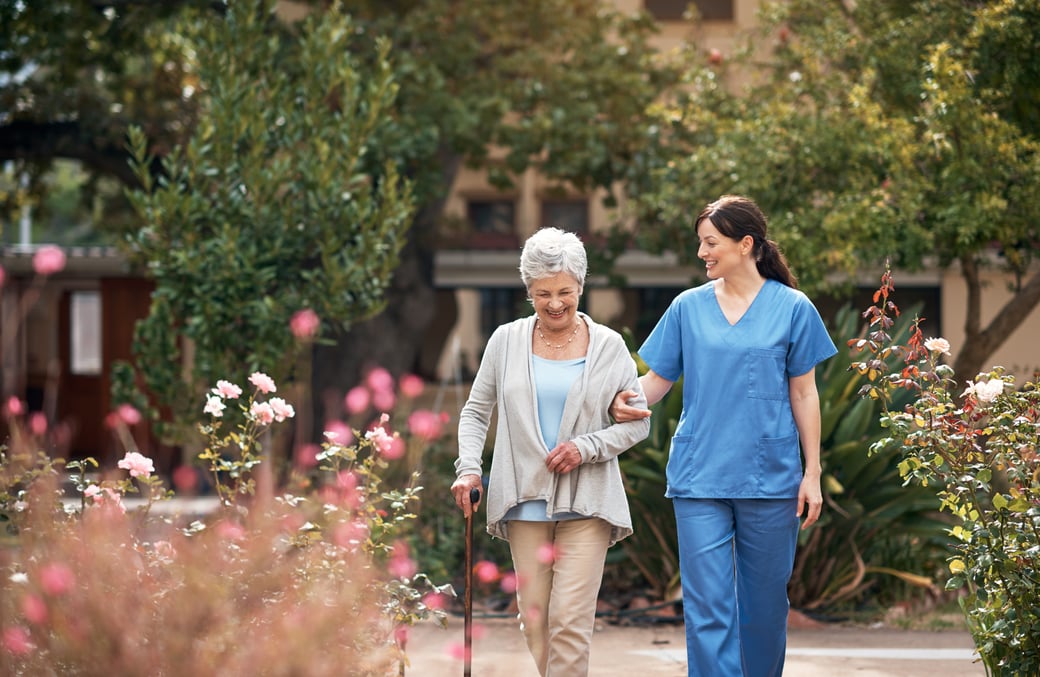 Senior woman taking a walk with nurse