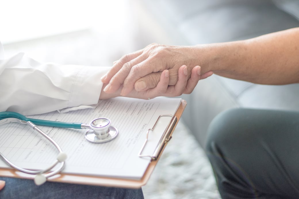 Doctor holding the hand of a senior patient