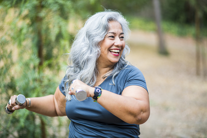 Woman exercises with a pair of free weights