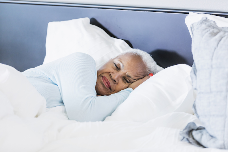 Senior woman sleeping in bed