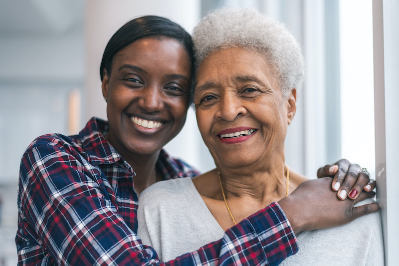 Young woman hugging grandmother