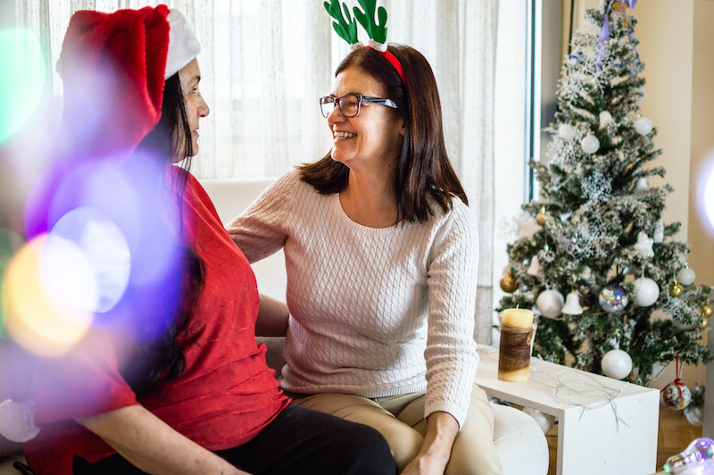 Woman visiting with senior for the holiday