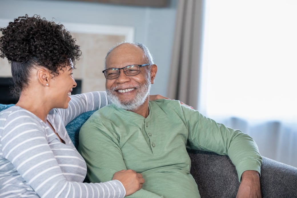 Daughter smiling with senior father