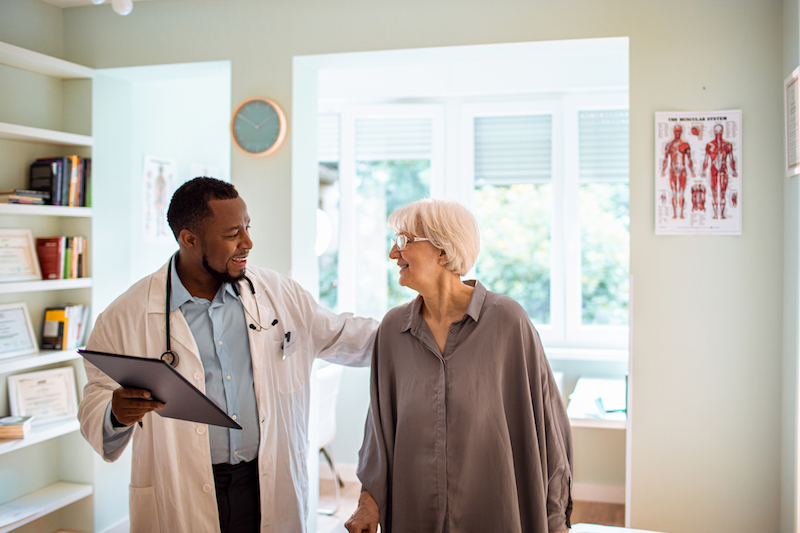Senior woman speaking with doctor