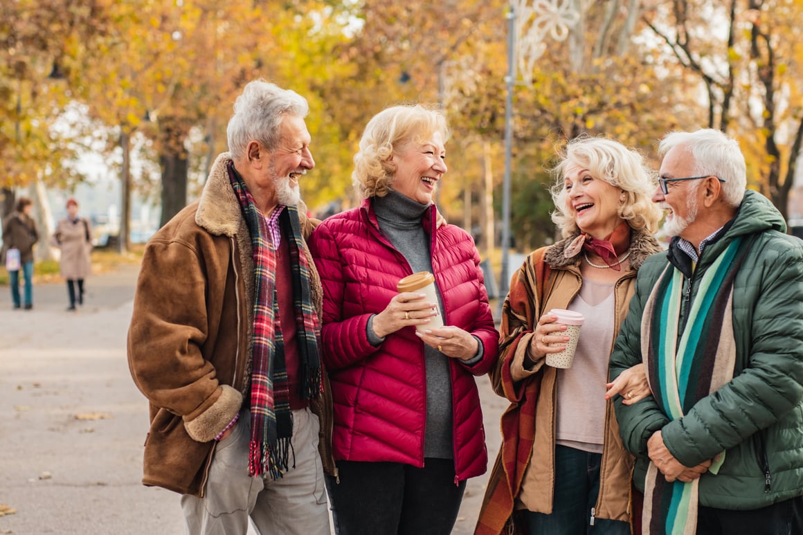 Group of senior friends laughing in a park