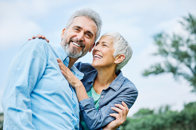 Senior couple smiling and embracing