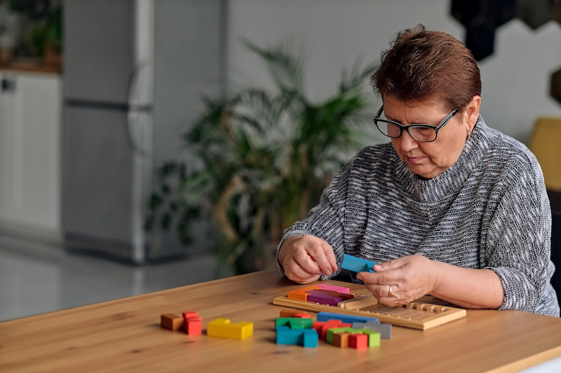 Senior woman working on a jigsaw puzzle