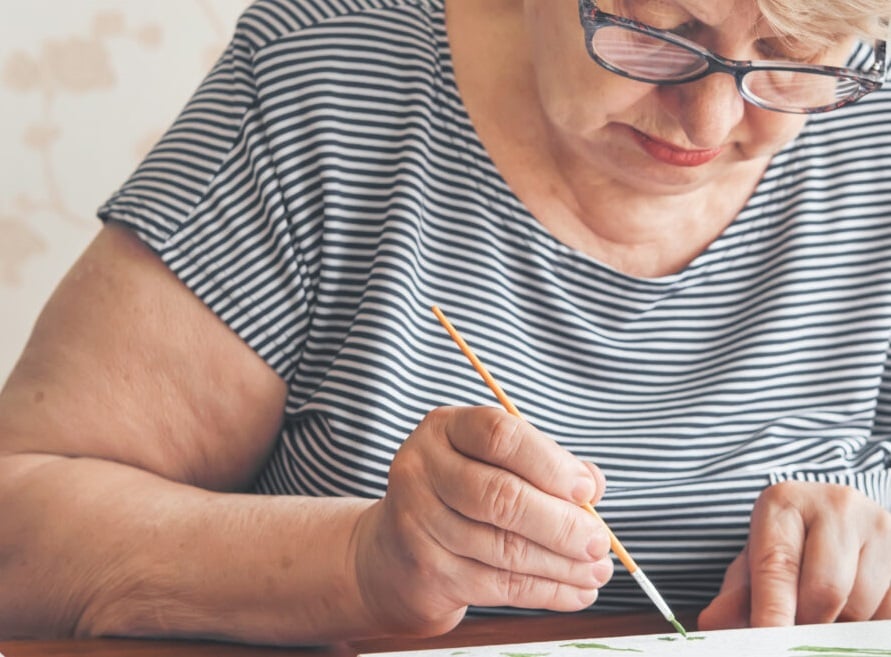 Senior woman painting