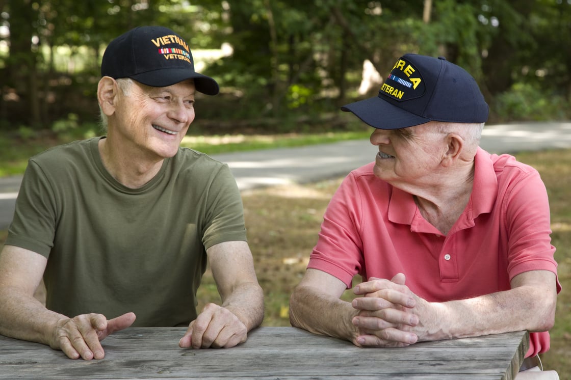 Two Veterans chatting on a park bench