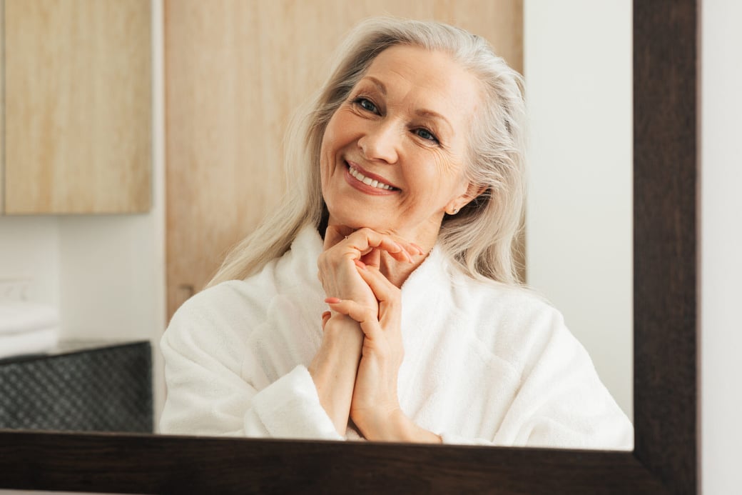 Senior woman looking in mirror