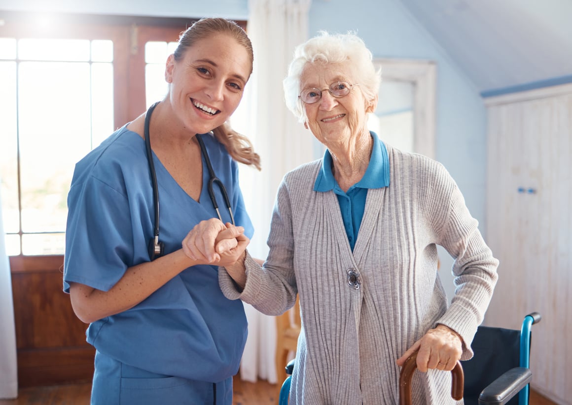Senior woman being assisted by young nurse