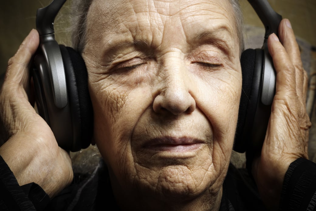 Senior woman listening to music with headphones