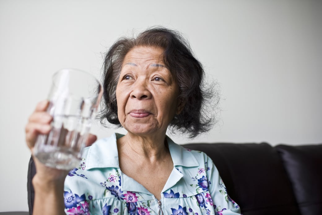 Senior woman drinking a glass of water