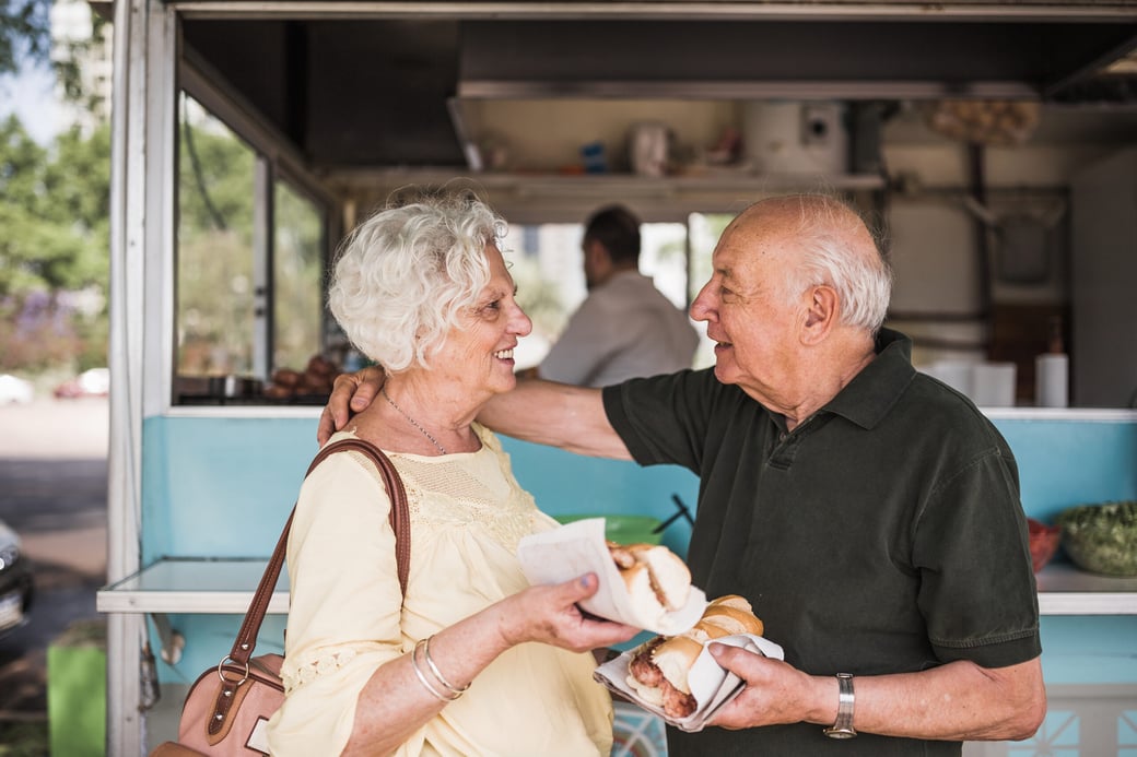 Senior couple getting food from an outdoor food truck