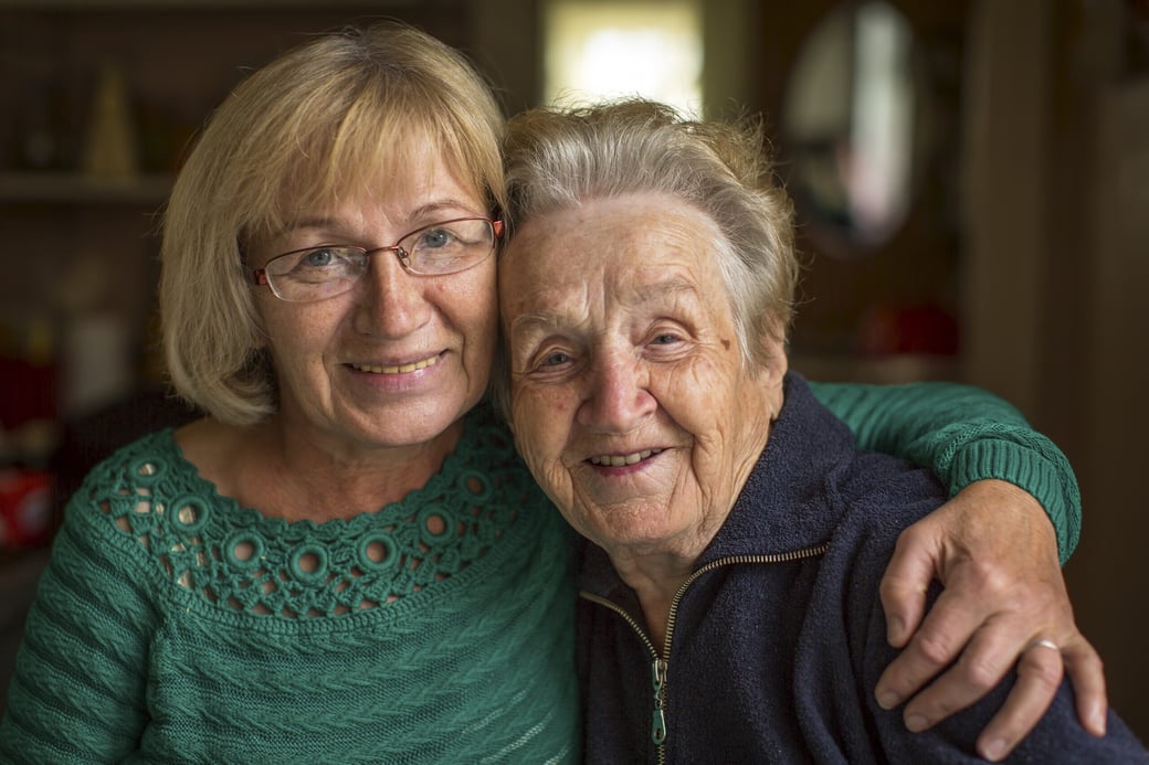 Woman hugging a senior woman