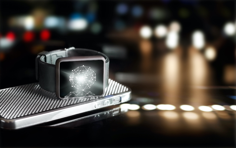Tech watch sitting on smartphone