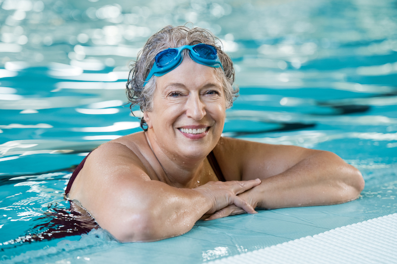 Senior woman swimming in pool