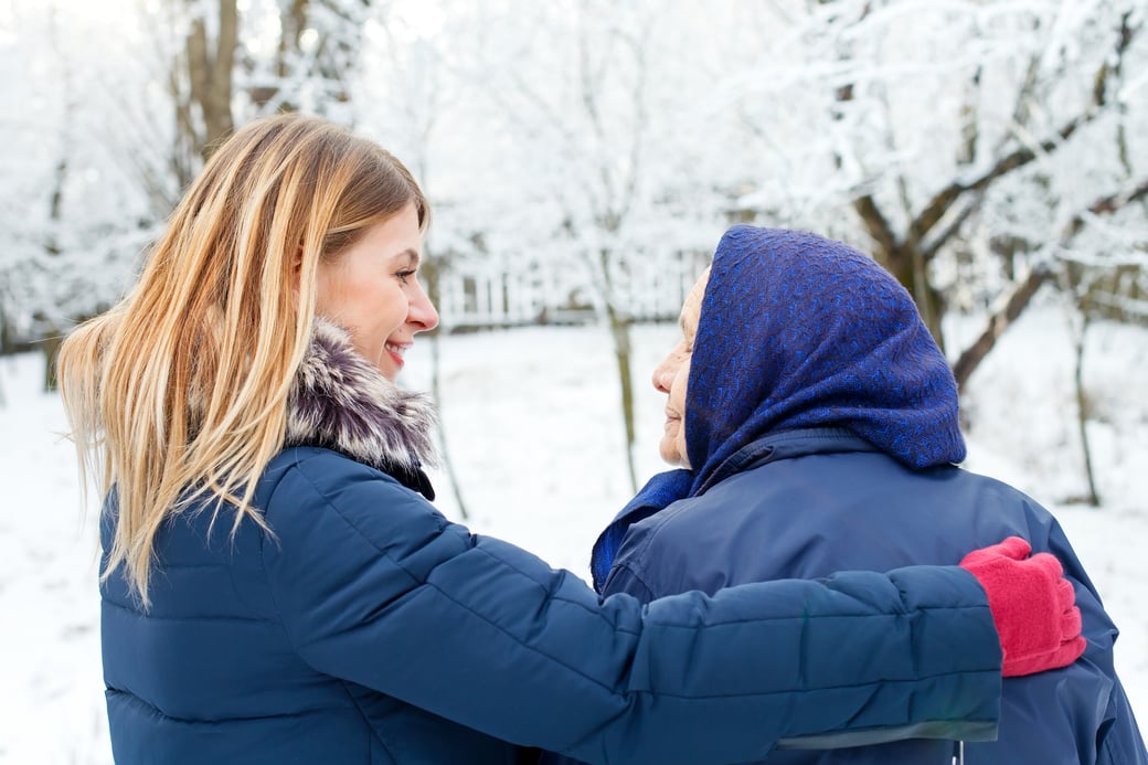 Granddaughter Walking in Snow with Grandmother