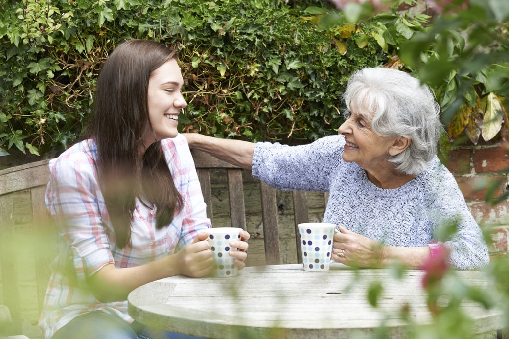 Senior woman having coffee with young woman