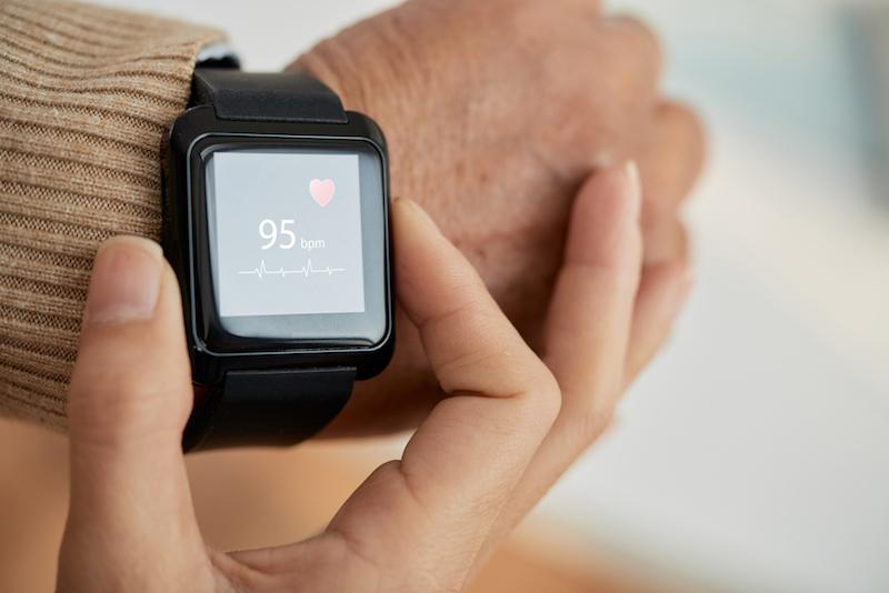 Woman reading heart monitor watch