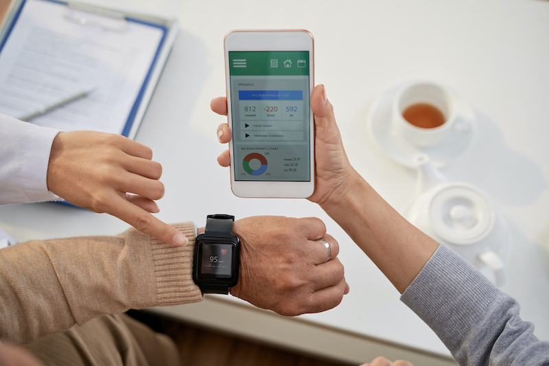 Man checking vitals on a watch and viewing the information on an app