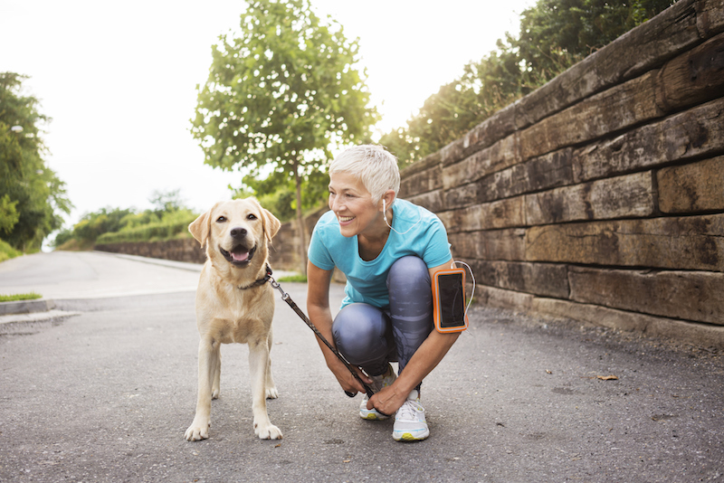 Senior woman out walking with dog