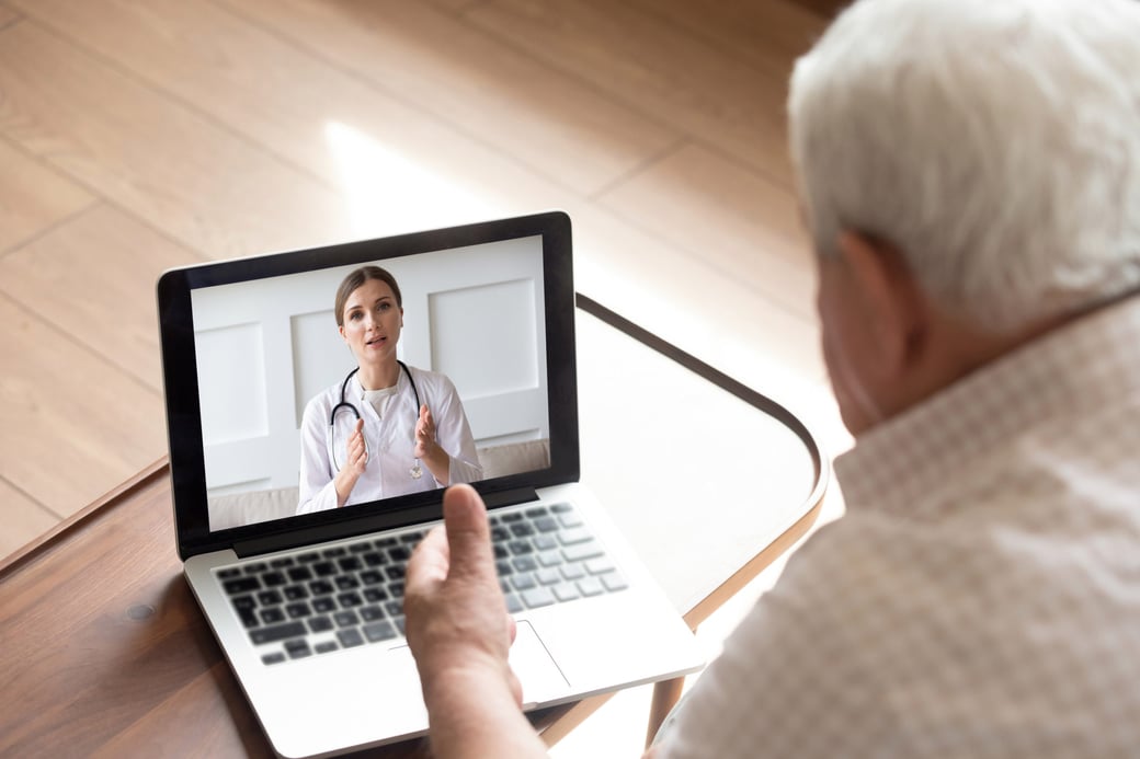 Senior man talking to doctor via telehealth on a computer