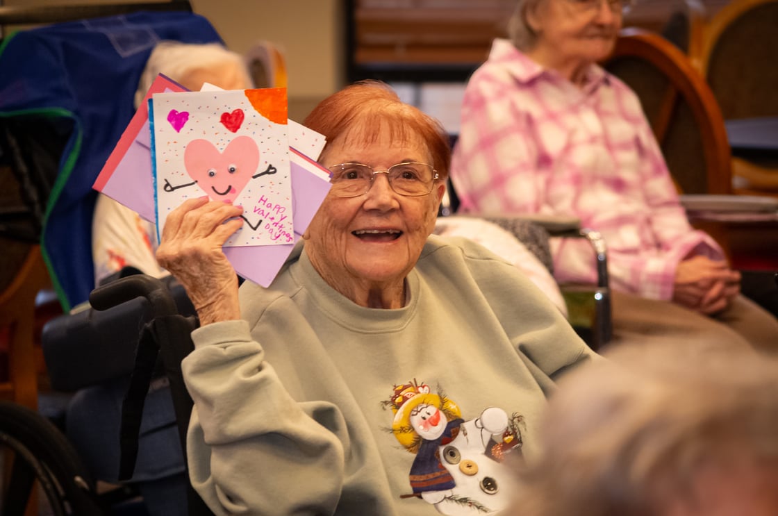 Bethesda Southgate resident holding up Valentine's Day cards